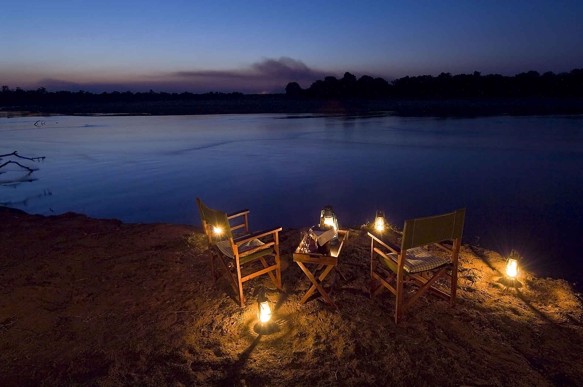 Camp, Gästechalet, Luangwa River, Nsefu Camp, Robin Pope Safaris, RPS, South Luangwa National Park, Abendessen, Flussufer, Öllampen, Sekt, afrikarma, afrikarma.de, Robin Pope