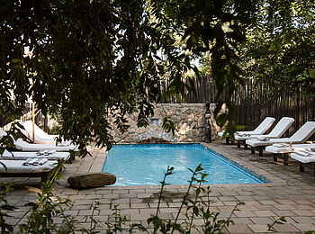 Simbavati River Lodge: Pool mit Liegen